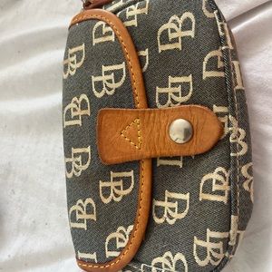This is a handbag and or wallet from the Y2K brand, Dooney and Bourke.